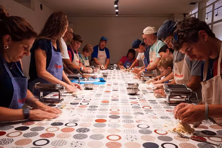 Group making fresh pasta in a Barcelona cooking class, highlighting hands-on culinary experience.