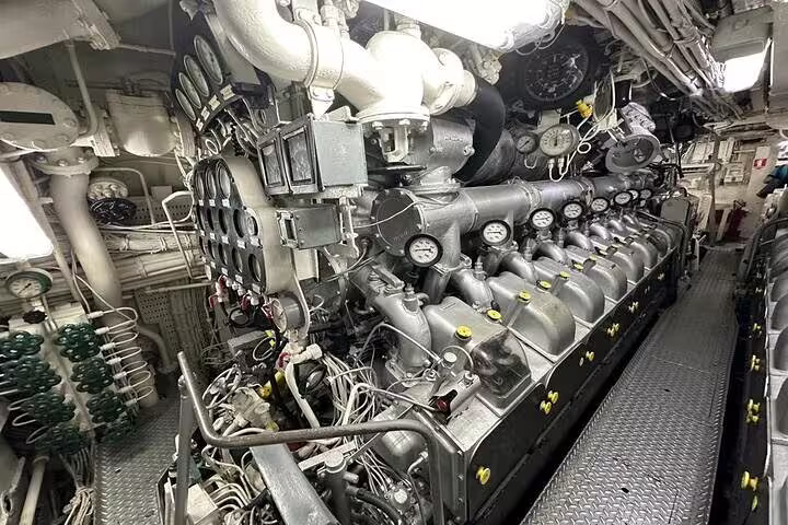 Complex machinery and gauges inside a ship's engine room, seen on the Guanabara Bay boat tour.