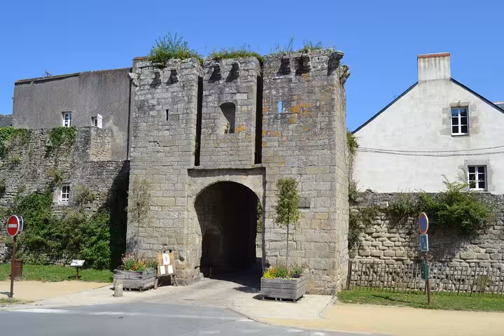 Medieval stone gateway with arched entrance and battlements in Guérande, France