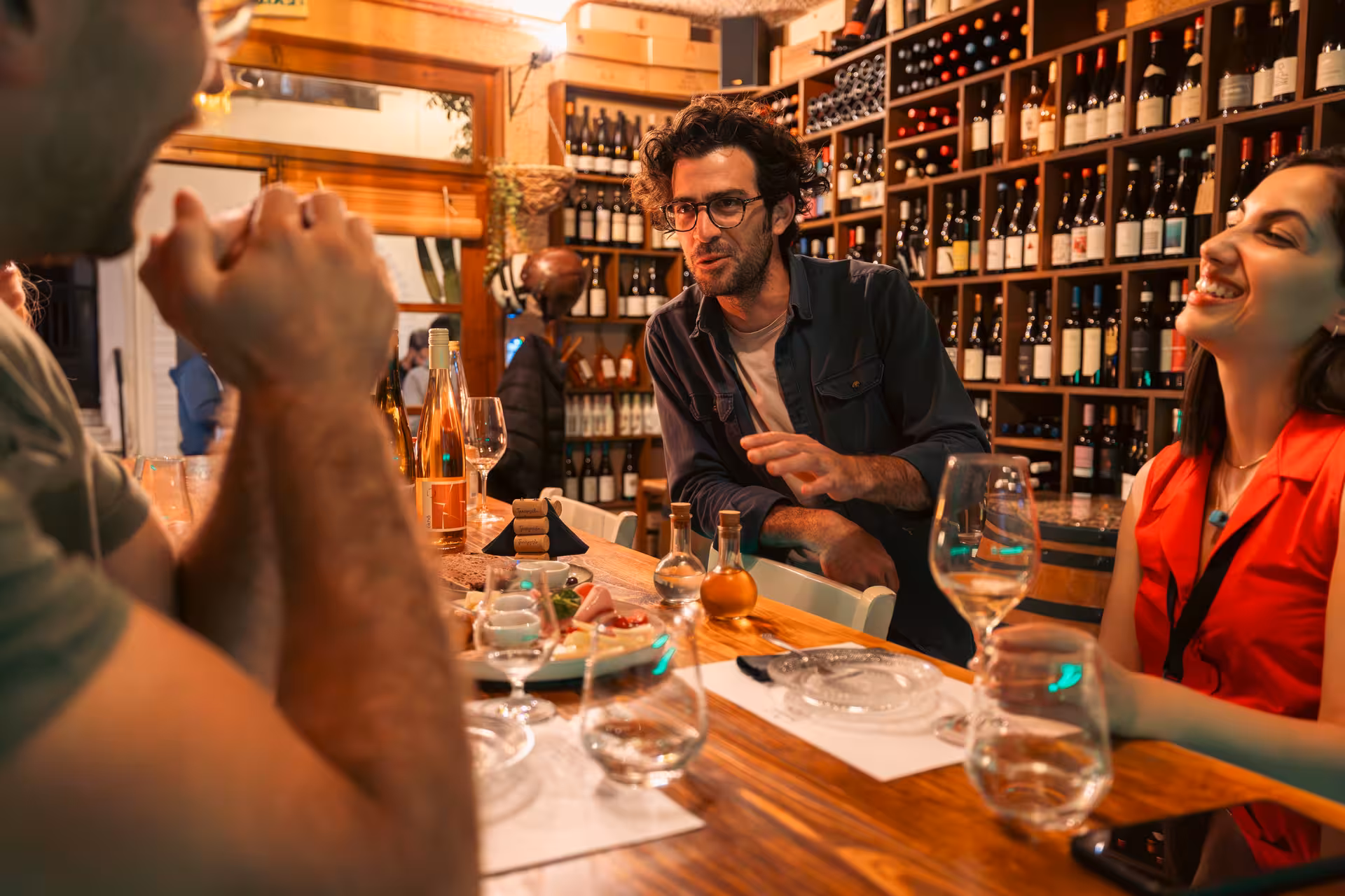 Guests tasting Greek wine with a host at a Naxos Town wine bar on the Munch Around Naxos Town tour, Greece