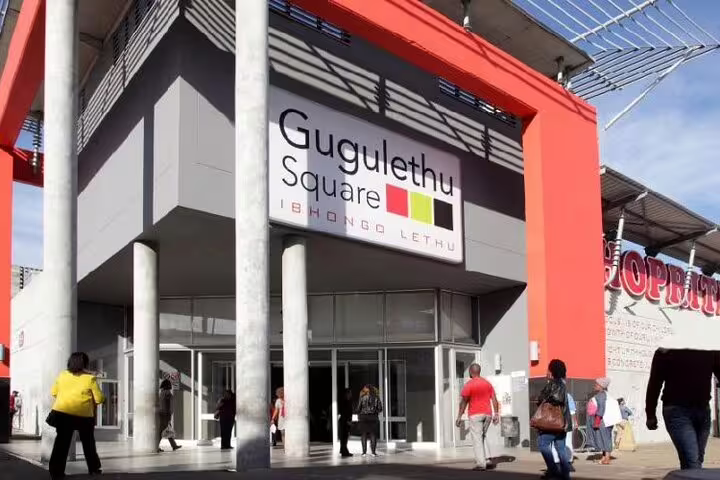 Visitors entering Gugulethu Square, a vibrant shopping hub in Cape Town's township tour of Langa, Gugulethu, and Khayelitsha.
