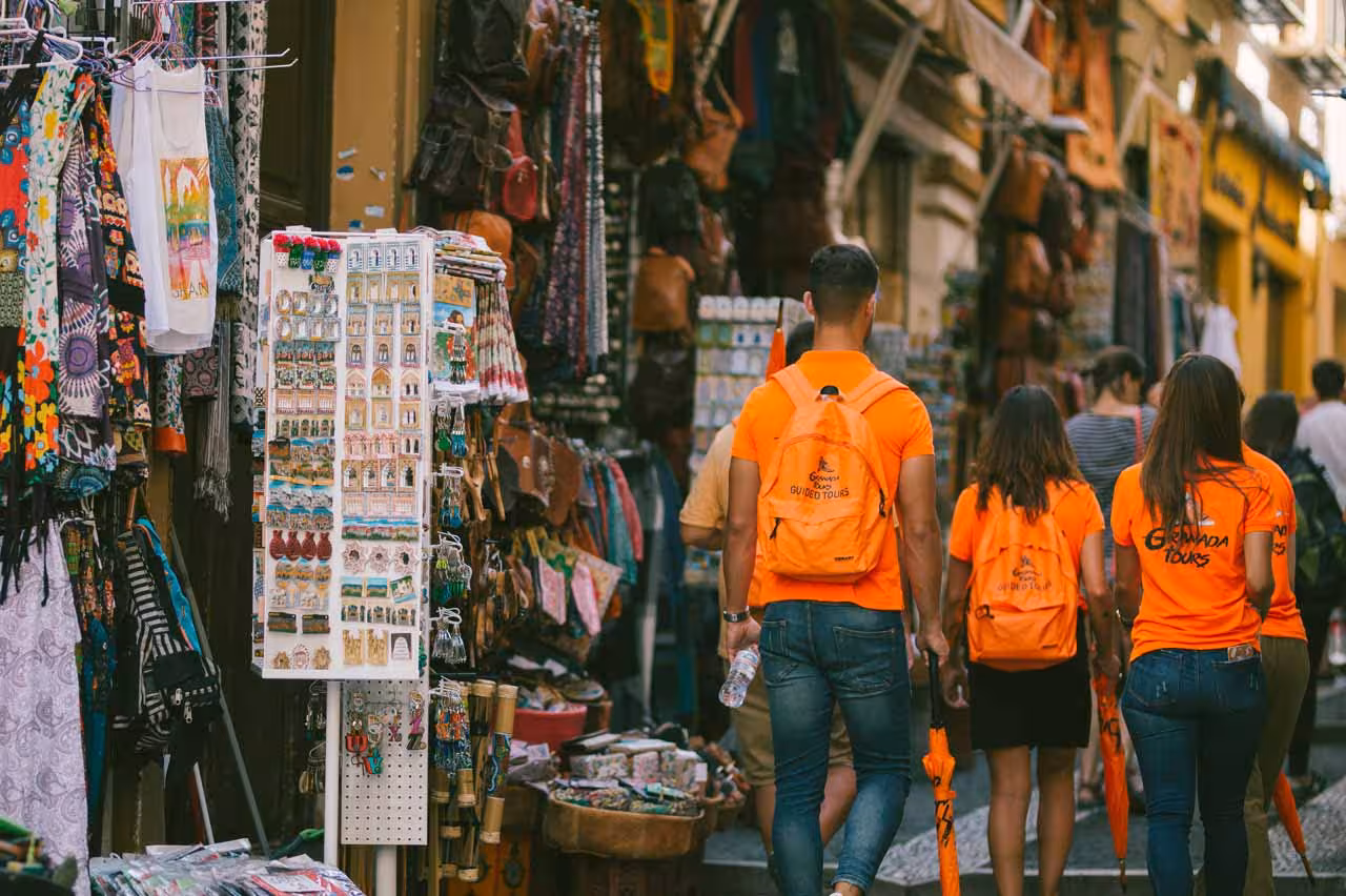 Tourists explore vibrant market stalls on a guided cathedral tour, enhancing their cultural experience.