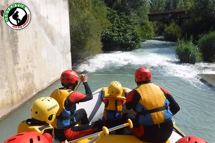 Guided rafting in Teruel with paddlers in helmets tackling gentle rapids on a scenic river stretch