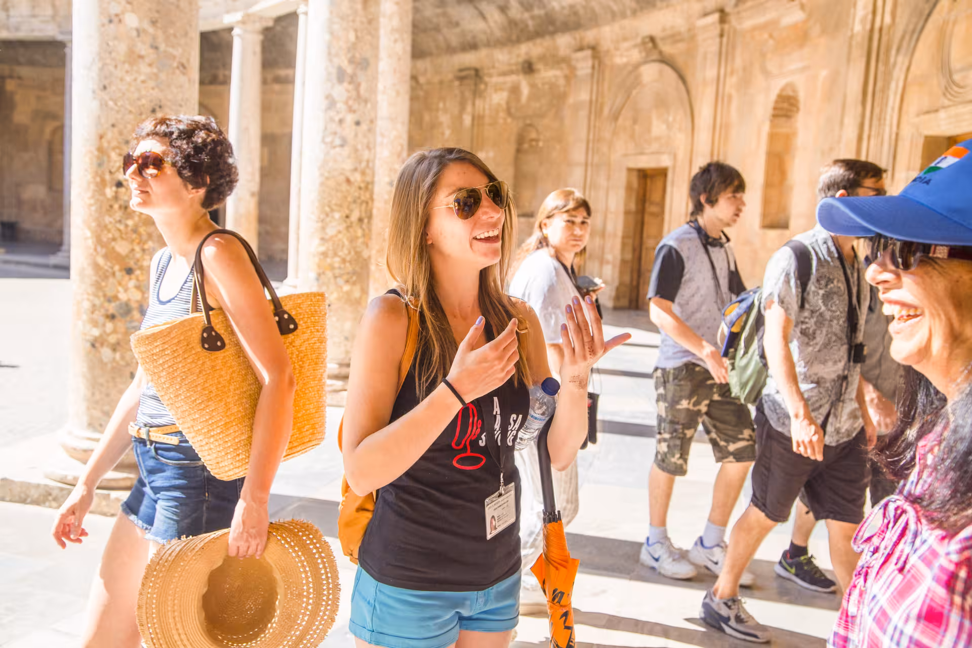 Tourists enjoying a guided tour of Alhambra's Carlos V Palace, highlighting its historical architecture and cultural richness.