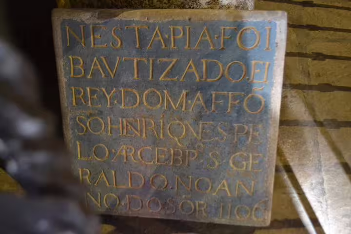 Historical inscription on a stone plaque in Guimarães, a highlight of the private half-day tour from Porto.