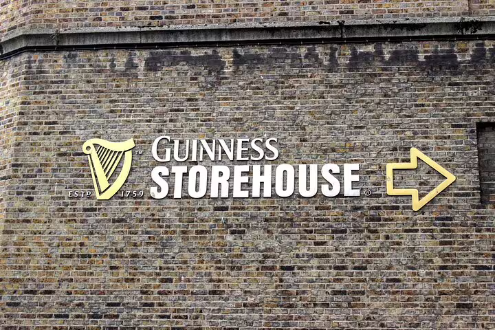 Guinness Storehouse sign with harp logo on brick wall, established 1759, Dublin