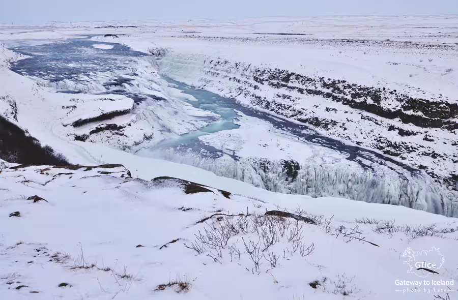 Gullfoss waterfall partially frozen in winter snow on Iceland's Golden Circle route