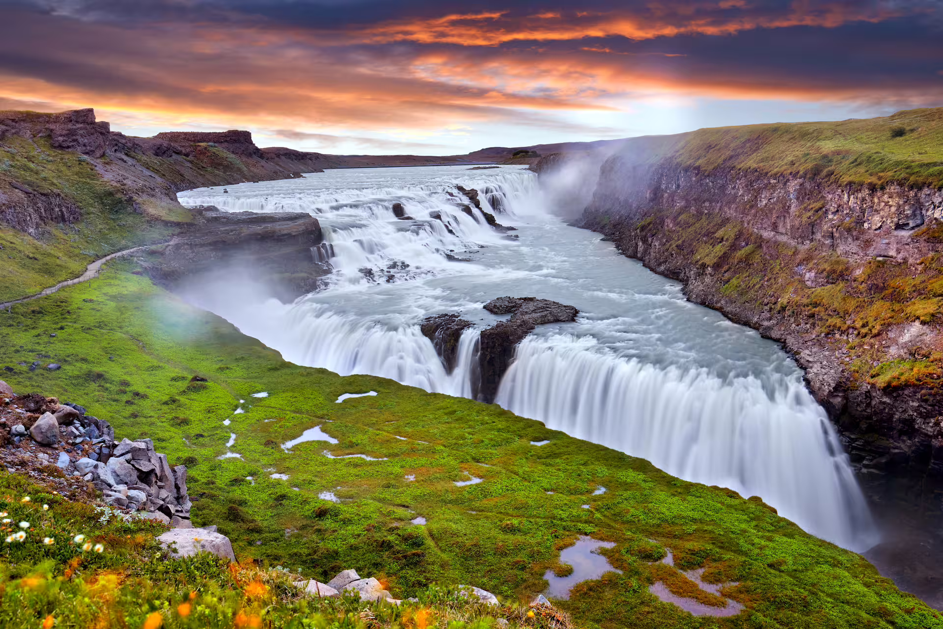 Gullfoss waterfall cascading into a canyon under a dramatic sunset sky, Golden Circle Iceland