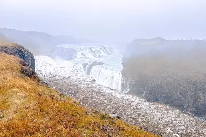 Gullfoss waterfall cascading into a misty canyon on Iceland's Golden Circle route