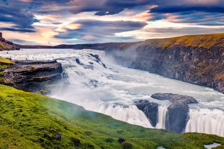 Gullfoss waterfall cascading into canyon with dramatic cloudy sky, Iceland Golden Circle