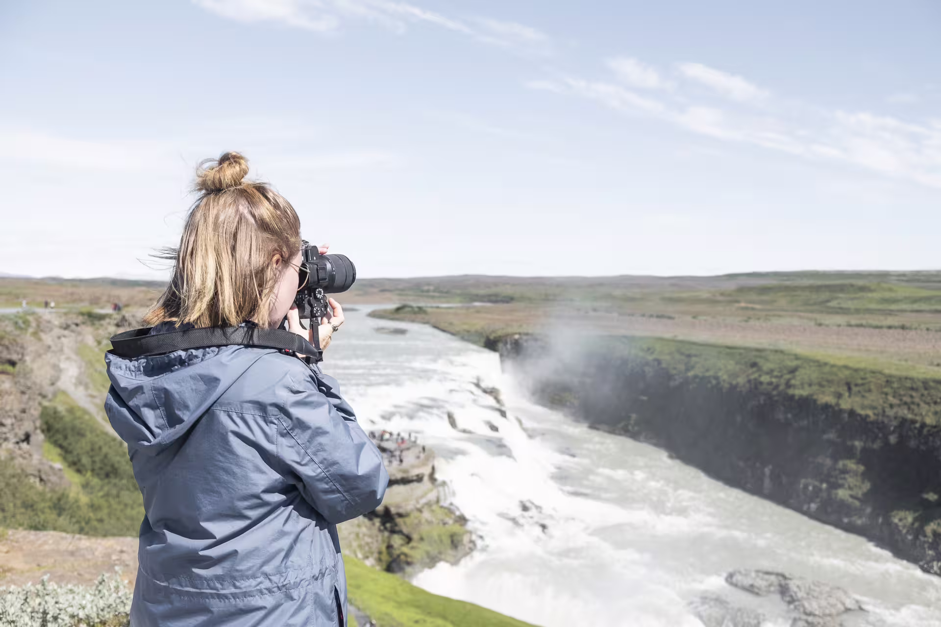 Photographer capturing Gullfoss waterfall on Iceland's Golden Circle tour