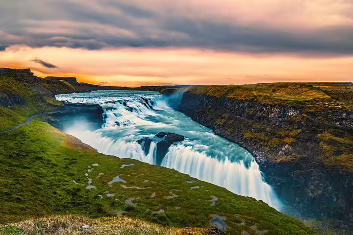 Gullfoss waterfall cascading into a canyon at sunset on Iceland's Golden Circle route