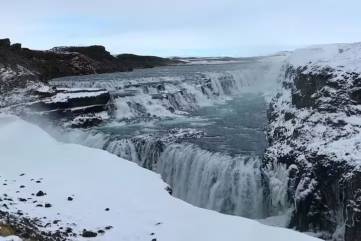 Gullfoss waterfall cascading into a snow-covered canyon in winter, Iceland Golden Circle
