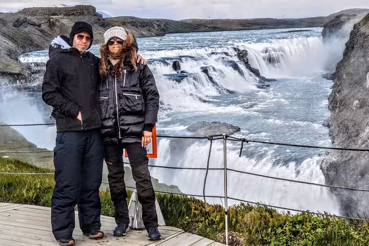 Couple posing in front of majestic Gullfoss waterfall on a private Golden Circle tour in Iceland