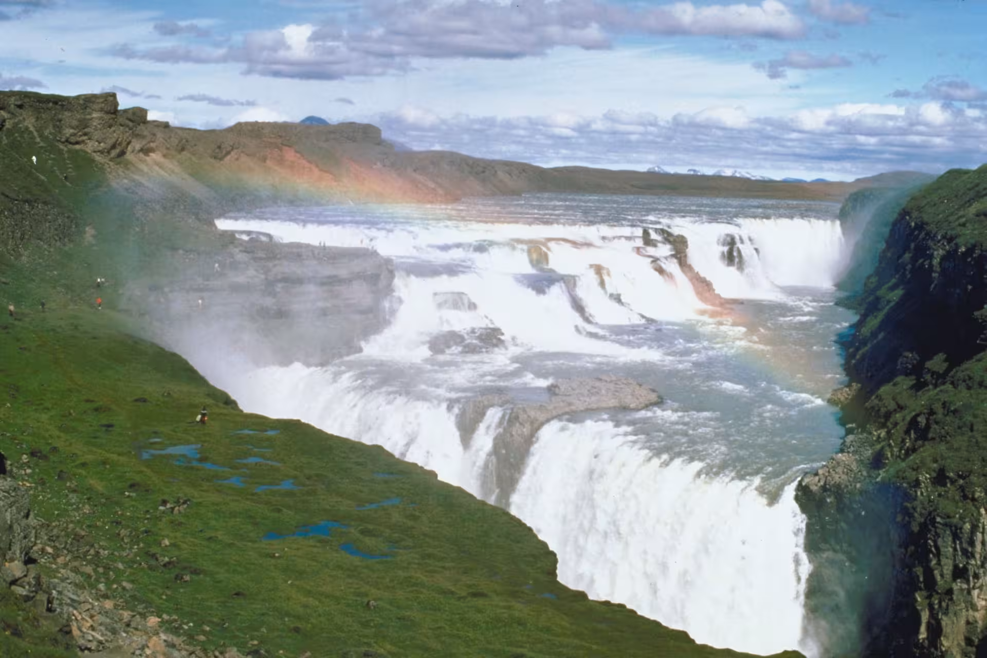 Gullfoss waterfall with rainbow and green cliffs on Iceland's Golden Circle route