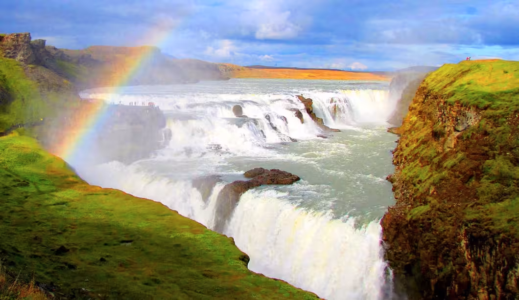 Gullfoss waterfall with rainbow and misty cascades on Iceland Golden Circle tour