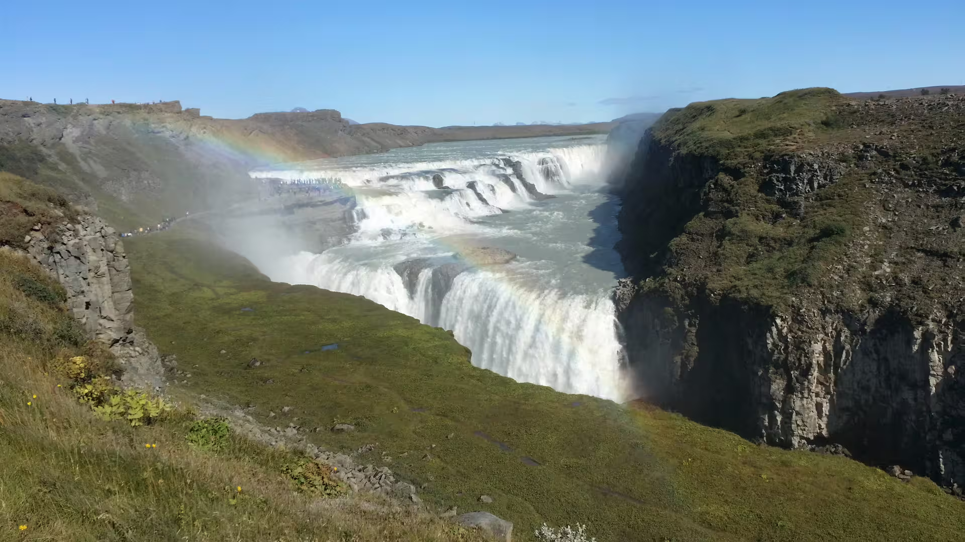 Stunning view of Gullfoss waterfall with vibrant rainbow, featured in Silfra Superjeep Golden Circle & Snorkeling Day Tour.