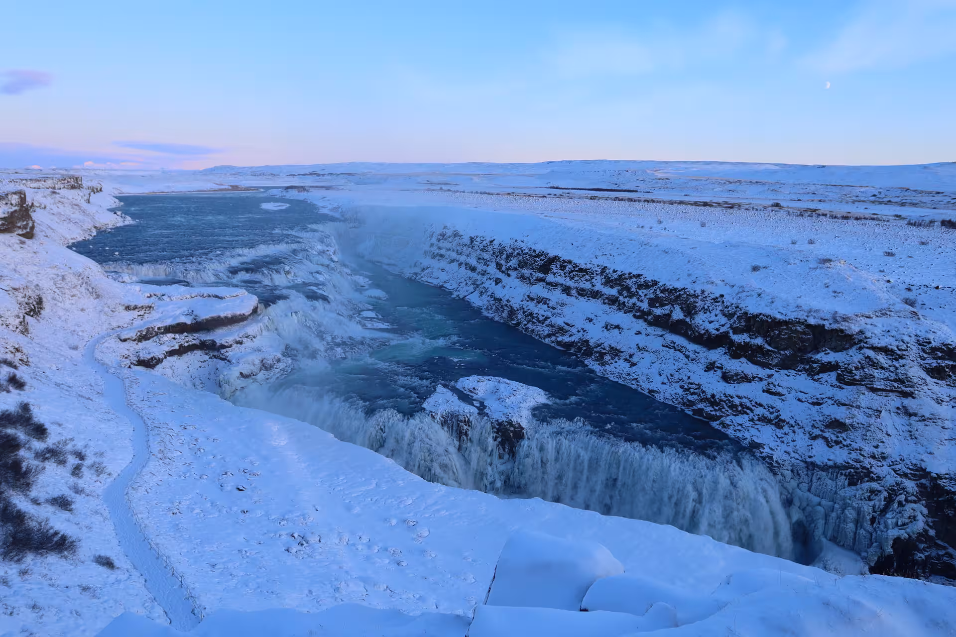 Gullfoss waterfall frozen in winter snow, Iceland Golden Circle landscape at dusk