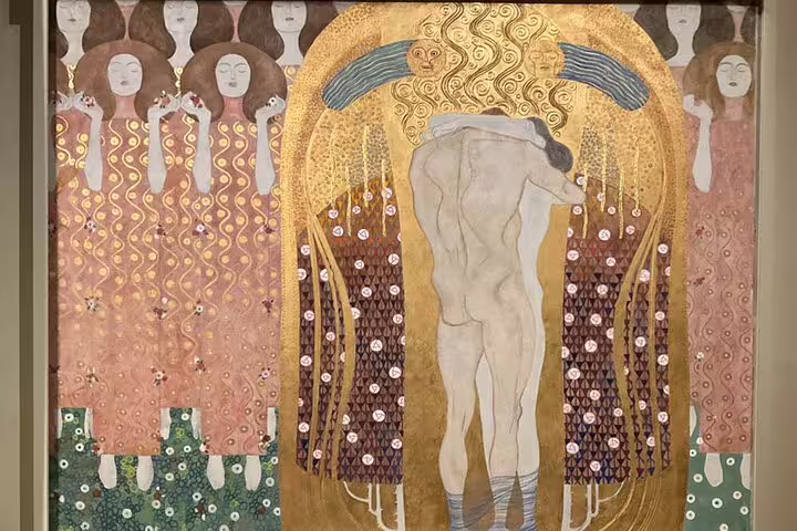Gustav Klimt's detailed mural with gold accents displayed at the Secession Building on a Vienna art tour.