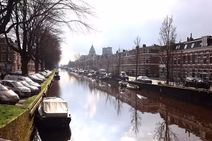 Haarlem canal with historic houses and moored boats, scenic stop on a 2-hour private walking tour