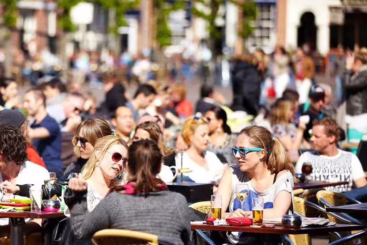 Haarlem Old Town private walking tour stop at a lively terrace café in the historic center on a sunny day
