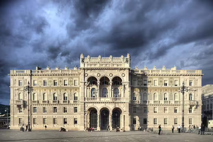 Grand Habsburg-era palace on Piazza Unità d’Italia in Trieste under dramatic storm clouds on a private walking tour