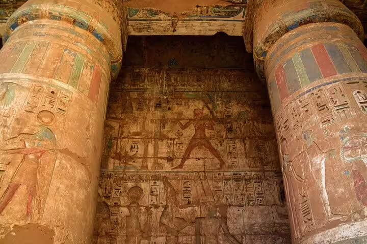 Vivid painted columns and ancient wall reliefs inside Habu Temple, Luxor West Bank Valley of Queens visit
