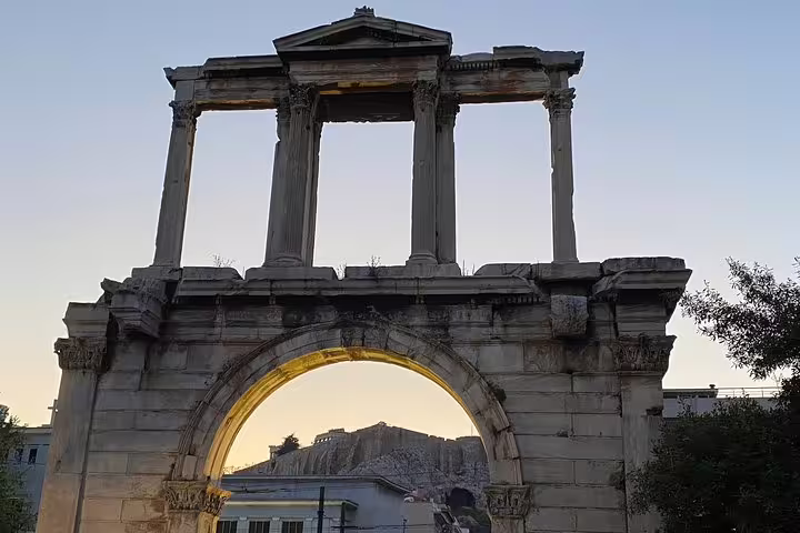 Hadrian’s Arch framing the Acropolis in Athens at sunset, highlight of skip-the-line Acropolis walking tour