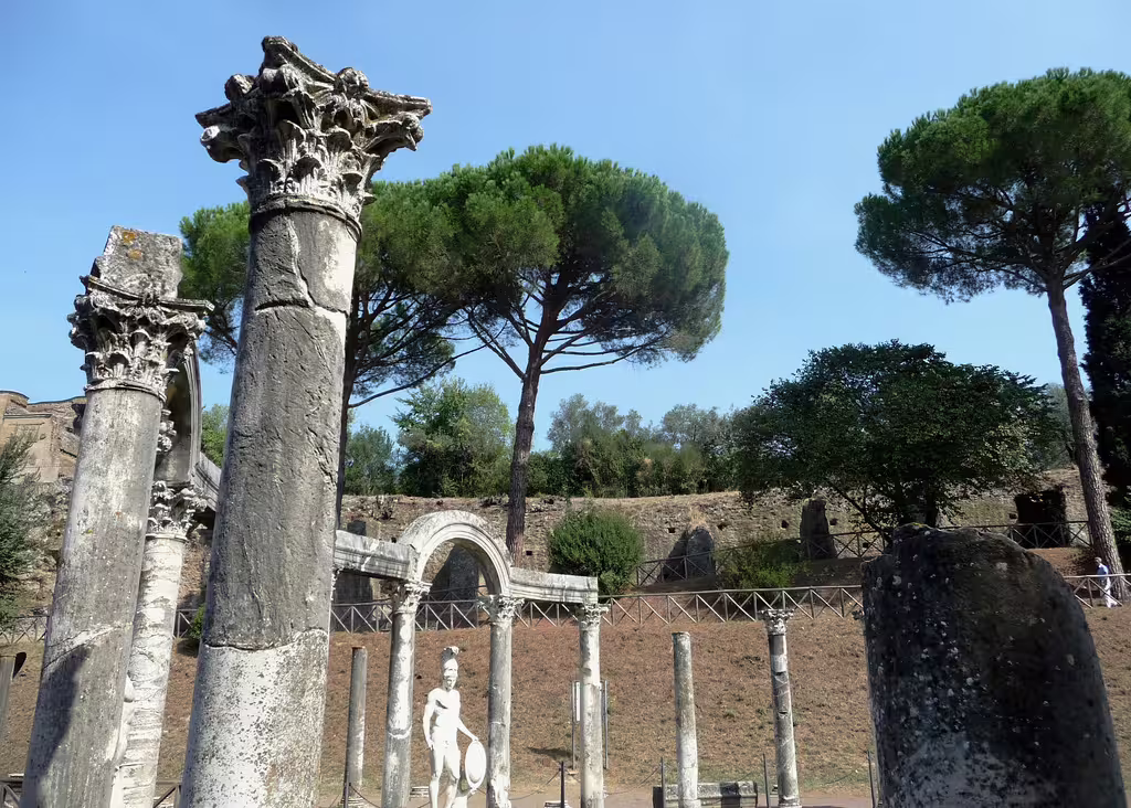 Ancient marble columns and statues among pine trees at Hadrian’s Villa near Rome on a guided small-group history tour