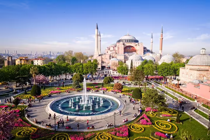 Vibrant gardens and fountains in front of Hagia Sophia, highlighting Istanbul's architectural beauty on a sunny day.