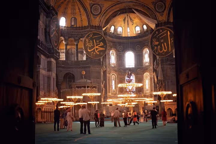 Inside Hagia Sophia with chandeliers and calligraphy, highlight of an all-inclusive private guided Istanbul tour