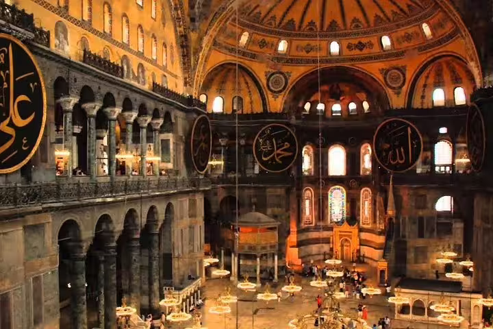 Hagia Sophia interior in Istanbul with grand dome and calligraphy, featured on Topkapi and Blue Mosque tour