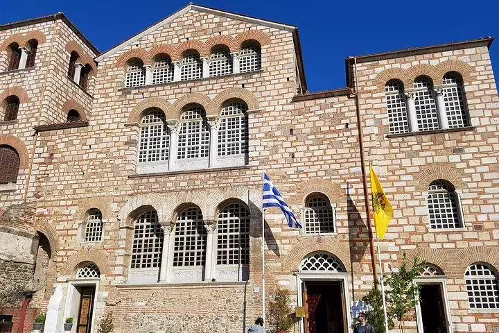 Facade of Hagia Sophia Thessaloniki with Greek flags, key landmark on a private historic walking tour