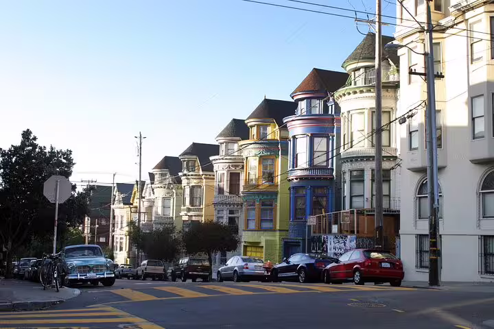 Colorful Victorian houses lining a sunny street in Haight-Ashbury, San Francisco