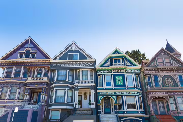 Colorful Victorian row houses with ornate details on a sunny street in Haight-Ashbury, San Francisco