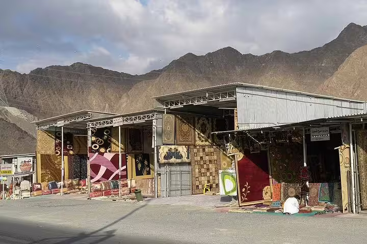 Traditional rug market nestled in the Hajar Mountains on a Full-Day Six Emirates Tour from Dubai.
