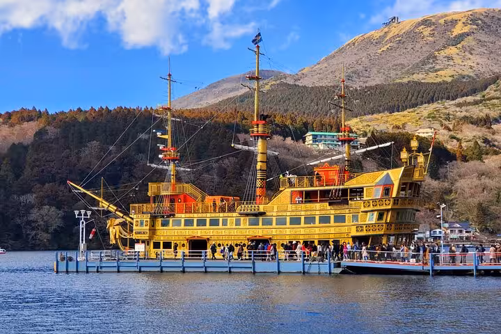 Hakone Lake Ashi pirate ship cruise with tourists boarding the iconic golden vessel on a 2-day Tokyo tour
