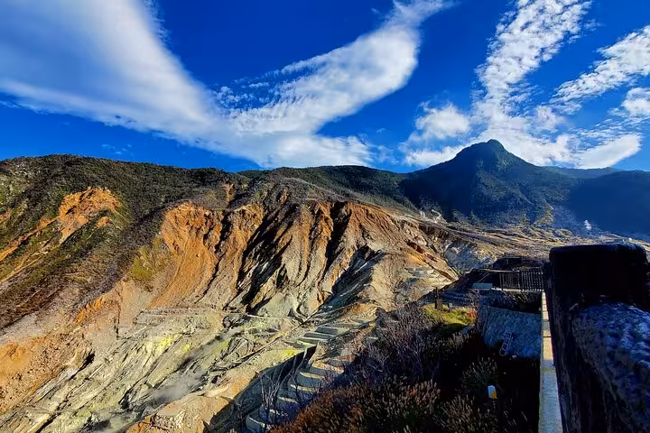 Scenic view of Hakone's rugged terrain under a bright blue sky, perfect for nature exploration on the custom tour.