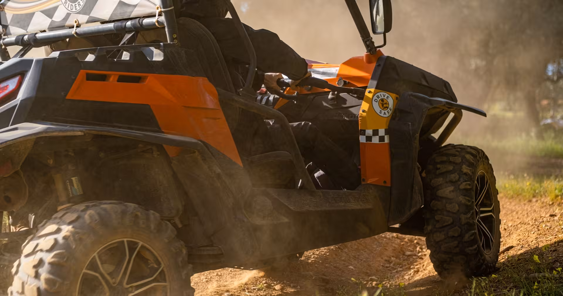 Off-road buggy kicking up dust on a rugged dirt trail during an adrenaline-filled half-day Algarve buggy tour adventure