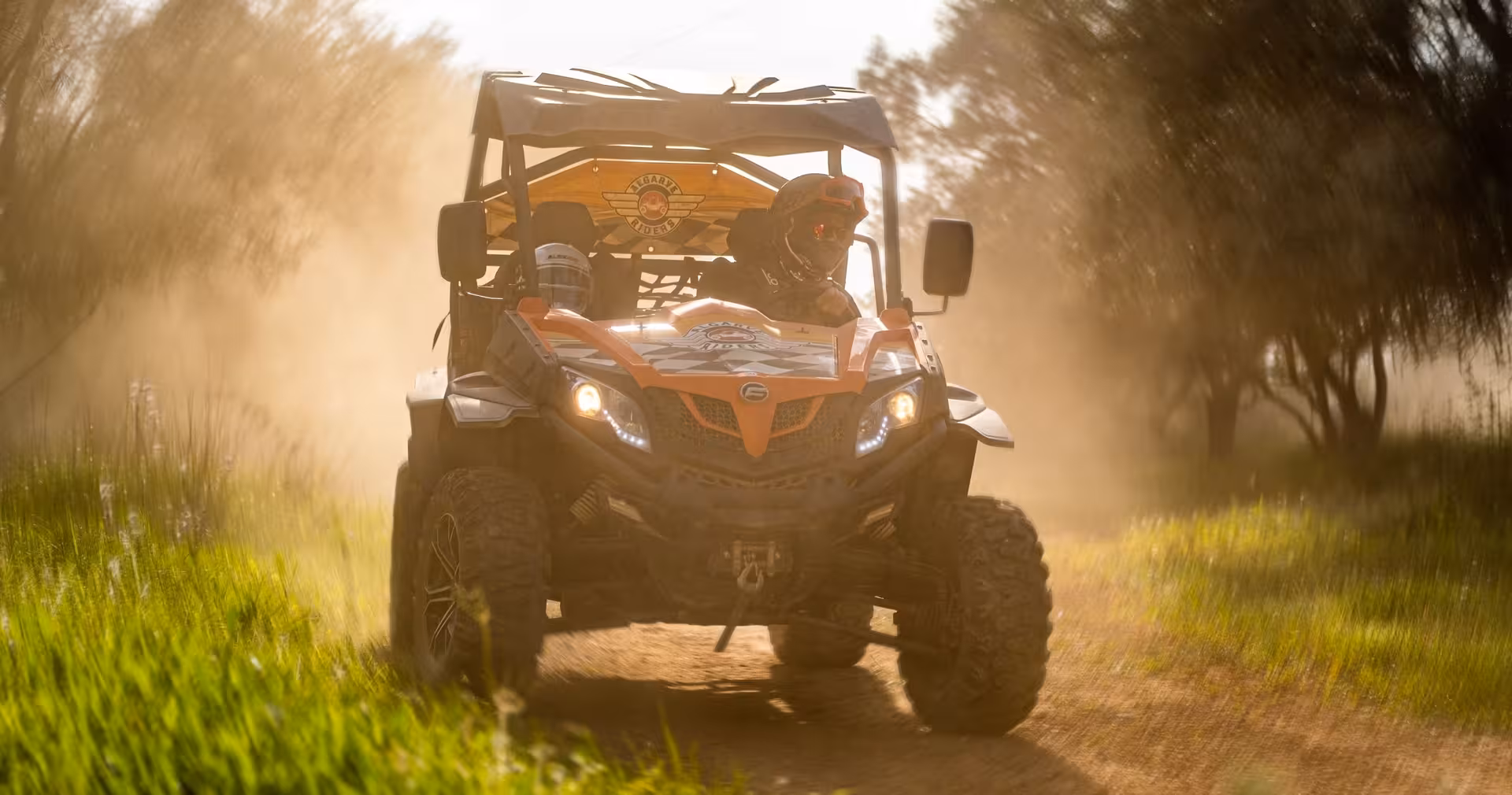 Guided half-day buggy tour racing along a dusty off-road trail through sunlit countryside, ideal for Algarve adventure holidays