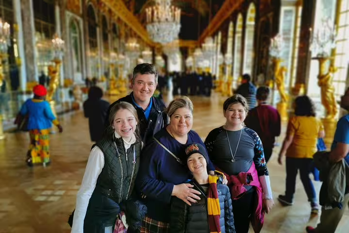 Visitors in the Hall of Mirrors at Versailles Palace during guided tour with skip-the-line tickets