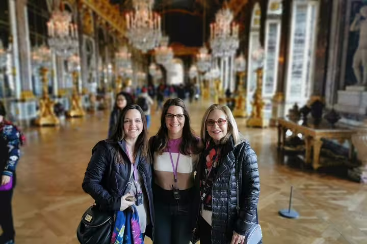 Visitors in the Hall of Mirrors at Versailles Palace on guided tour with skip-the-line tickets and guide