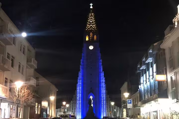 Hallgrímskirkja church illuminated in blue lights at night in Reykjavik city center
