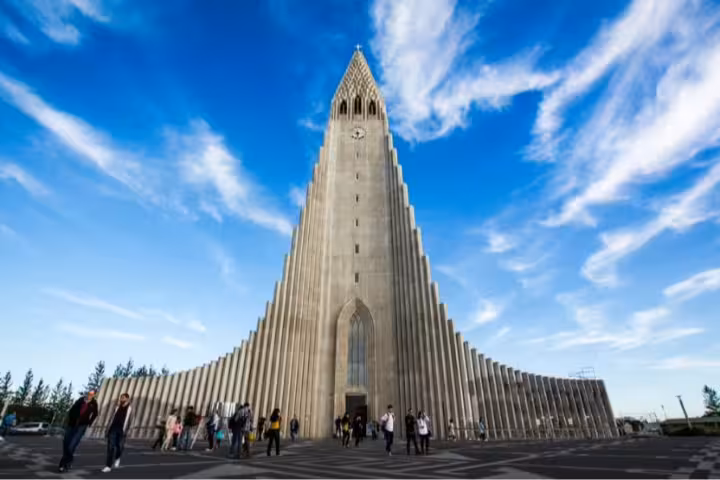 Hallgrímskirkja church towering over visitors in Reykjavik under a bright blue sky