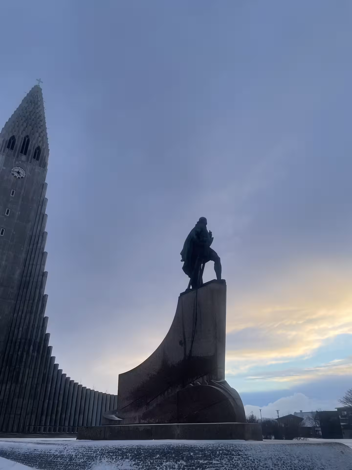 Leif Erikson statue silhouette in front of Hallgrímskirkja church tower at dusk, Reykjavik