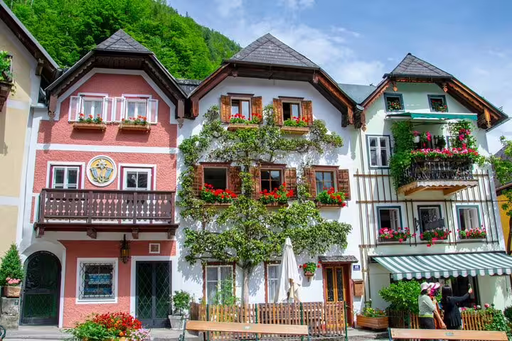 Colorful traditional Austrian houses with flower-adorned balconies in Hallstatt village