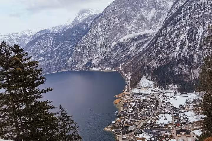 Panoramic Hallstatt and Lake Hallstatt framed by snowy Alps, iconic viewpoint on small-group day trip from Vienna