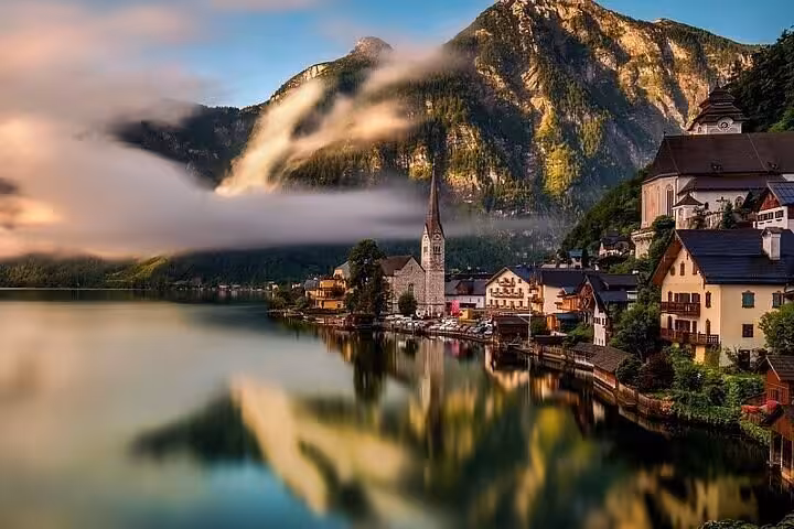 Sunrise over Hallstatt with misty mountains reflected in lake on Salzburg and Castle Ort private tour from Vienna