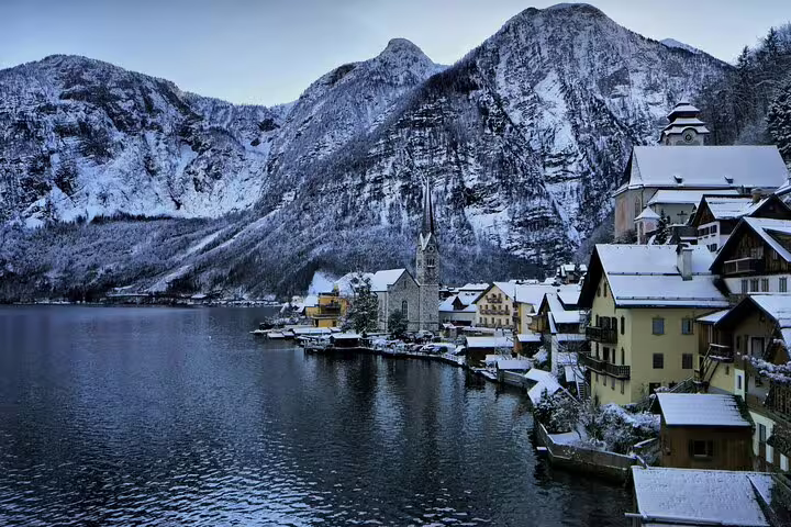 Snowy Hallstatt waterfront and alpine mountains, key photo spot on a self-guided scavenger hunt and highlights tour
