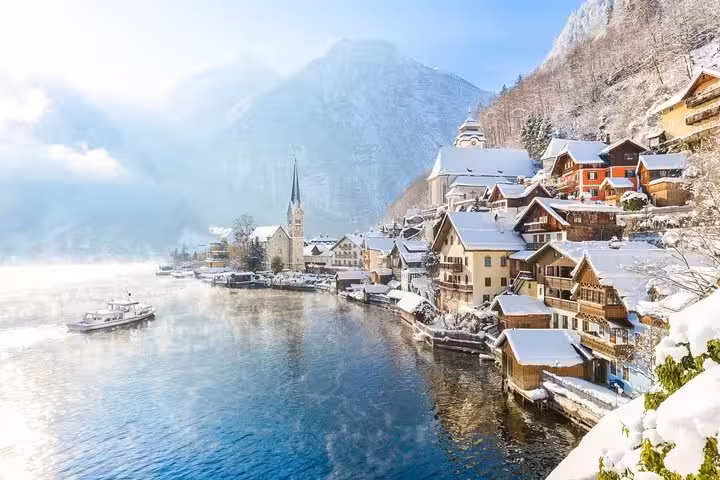 Hallstatt village in winter with snowy rooftops and lake, small-group Christmas Day trip from Vienna